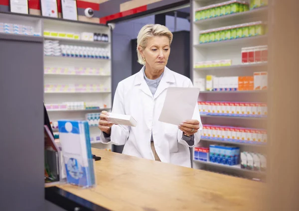 Pharmacy, doctor and medicine prescription paper in retail store with mockup healthcare stock. Pharmacist woman reading info on pills, box or Pharma product for medical service, health and wellness.