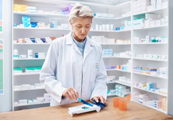 Pharmacy woman, pills and counting in store for stock, product and medicine for health on table with tools. Pharmacist sorting, management and focus for retail pharma for healthcare service in shop.