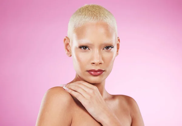 Portrait, beauty and face with a model black woman in studio on a pink background for edgy cosmetics. Makeup, skincare or natural with a unique and attractve young female indoor for cosmetic care.