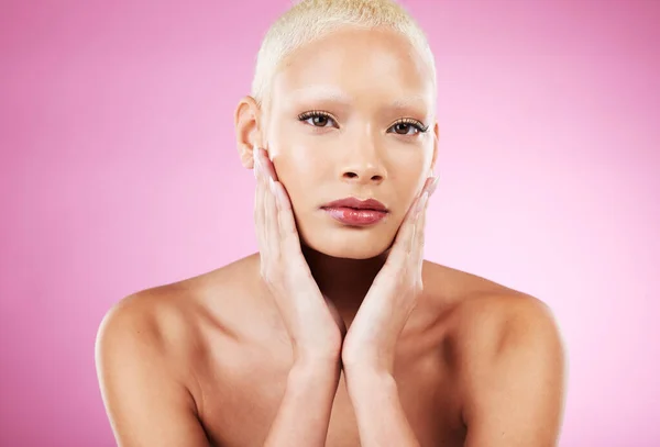 Portrait, skincare and makeup with a model black woman in studio on a pink background for edgy cosmetics. Face, beauty or natural with a unique and attractve young female indoor for cosmetic care.
