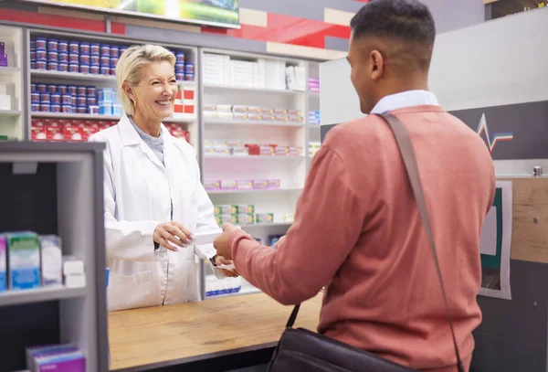Pharmacist, doctor and customer for medicine in store with mockup stock for healthcare. Woman and man talking for advice on pills or Pharma product for medical retail service, health and wellness.
