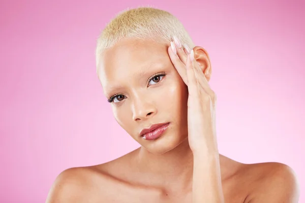 Portrait, beauty and makeup with a black woman in studio on a pink background for edgy cosmetics. Face, skincare or natural with a unique and attractve young female model indoor for cosmetic care.