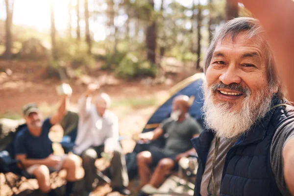 Camping, selfie and senior man with friends in nature taking pictures for happy memory. Asian, face portrait or group of elderly men take photo for social media after trekking hike outdoors at camp