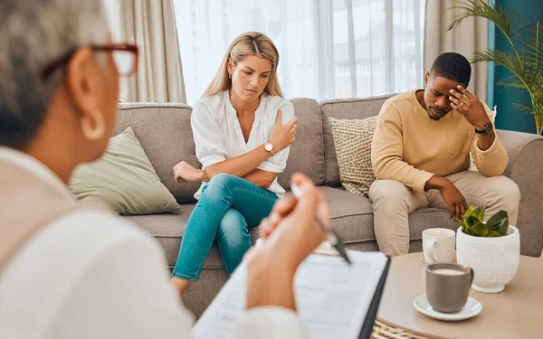 Couple on sofa, psychologist with clipboard for mental health advice and consulting in office. Stress, anxiety and depression, sad black man and woman and healthcare therapist in consultation room