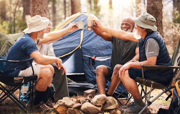 Man, friends and camping with cheers to coffee in nature for travel, adventure or summer getaway on chairs by tent in forest. Group of men relaxing and drinking in celebration for outdoor camp.