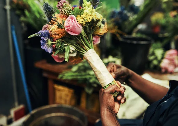Flowers are natures gifts to us. an unrecognizable florist wrapping up a bouquet of flowers inside a plant nursery