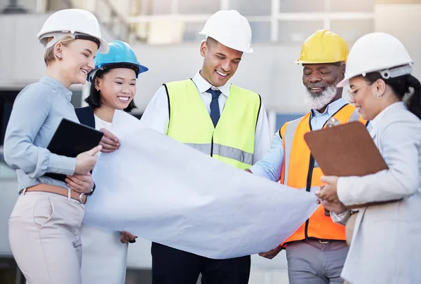Architect, building and construction team with blueprint in planning strategy, meeting or project layout on site. Group of diverse engineers or contractors discussing floor plan for city architecture.