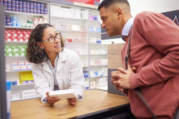 Pharmacist, medical information and customer with senior woman talking about pills side effects. Reading, prescription info and healthcare worker consulting for health support and wellness check.