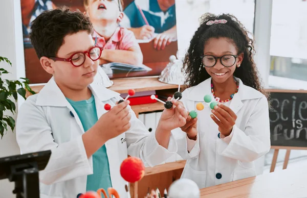 Theyre the future of science. an two adorable young school children learning about molecules in science class at school