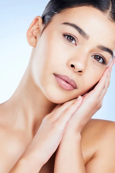 Portrait, aesthetic and spa with a model black woman in studio on a blue background for skincare. Face, beauty and skin with an attractive young female posing to promote natural facial treatment.