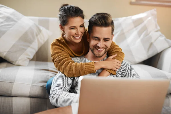 I cant wait to check out this place. a young couple using a laptop while relaxing at home