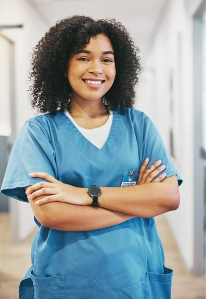 Nurse, portrait and black woman with arms crossed in hospital for healthcare. Medical, wellness and happy, confident and proud female physician, professional or doctor from South Africa in clinic
