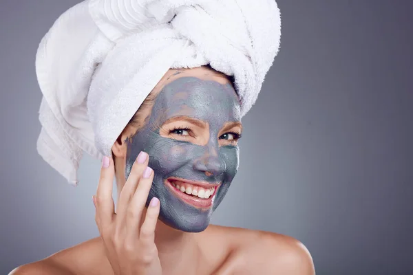 Woman, clay makeup and mask portrait for facial, detox beauty and studio background. Happy female model, charcoal skincare product and face cosmetics for cleaning, shower and aesthetic transformation.