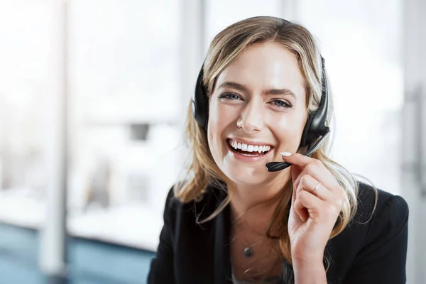 She pours passion into every call. Portrait of a young woman using a headset in a modern office