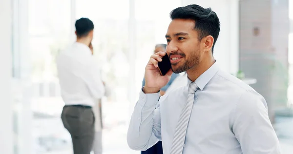Businessman, communication and phone call with mobile networking at financial advisory startup company. Conversation, b2b and business man consulting on smartphone, talking and standing in office