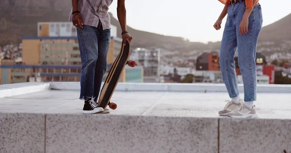 Skateboard, friends and city with a man and woman skating on a rooftop outdoor during the day. Sport, exercise and summer with a male and female training as a street skater in an urban town.