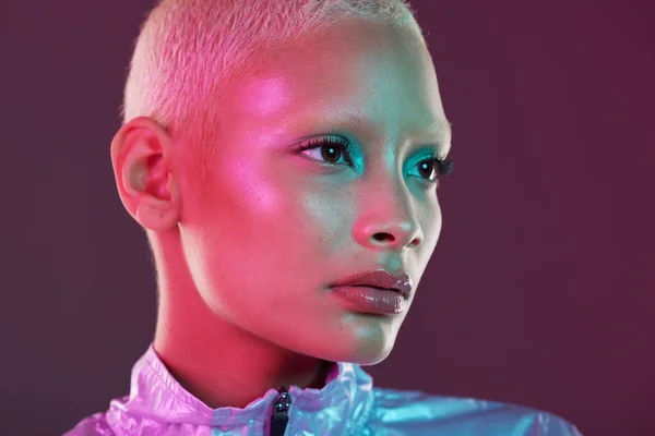 Vaporwave profile, black woman and cyberpunk cosmetics with model thinking in a studio. Isolated, glow makeup and futuristic cyber fashion of a young person with chrome clothing and scifi design.