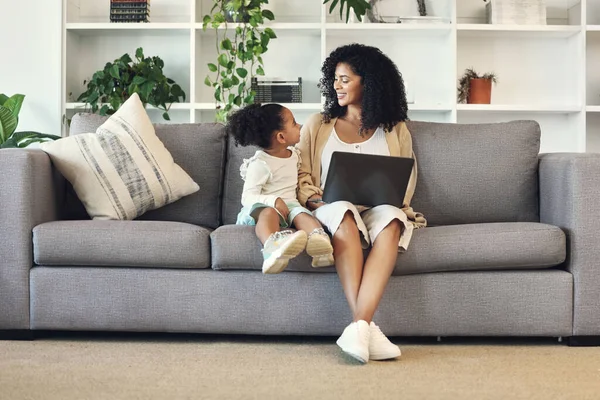 Child, mother and laptop in family home living room for remote work, online education and wifi. Happy woman and girl kid talking on couch with internet for learning, games and watch movies to relax.