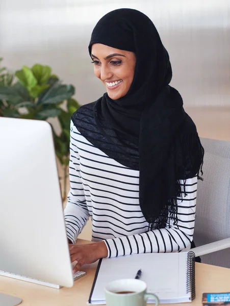 Happy, computer or graphic designer Muslim woman planning for creative search, website strategy or branding in office. Startup or employee at desk working on SEO transformation, typing email or idea.