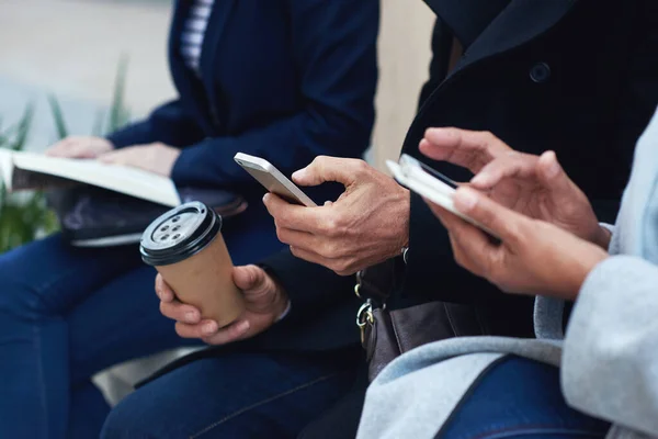 Group hands, phone and coffee in communication, social media or networking for chatting or texting. Hand of people typing on smartphone in waiting room on mobile app or online browsing on technology.