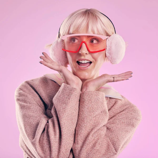 Fashion, woman and quirky in studio with wow, surprise and comic glasses on pink background. Aesthetic model person with hands on face thinking about edgy vaporwave trend with creativity and color.