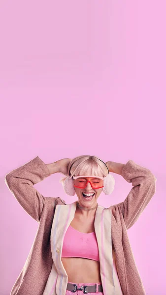 Fashion, comic and a woman with mockup in studio while laughing for funny space on pink background. Aesthetic model person with glasses for edgy vaporwave trend with creativity and color advertising.