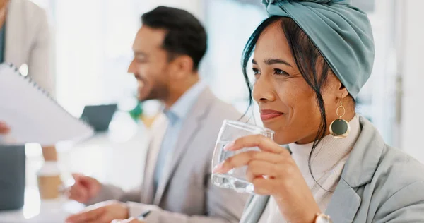 Business woman, drinking water and smile on face while in a corporate meeting for planning a collaboration with a team. Female entrepreneur happy and thinking about idea while at workshop or training.