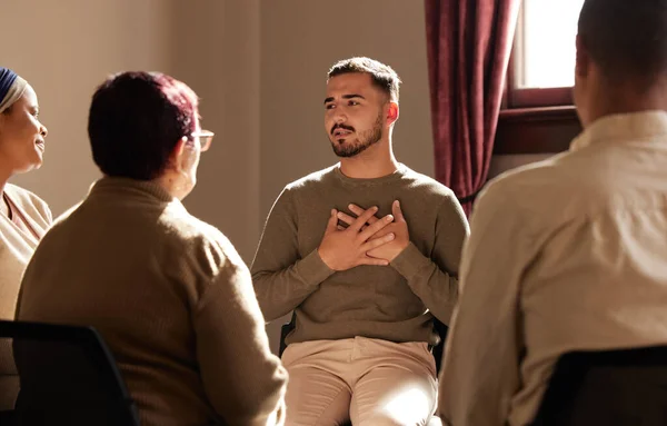 Support, trust and man sharing in group therapy with understanding, feelings and talking in session. Mental health, addiction or depression, men and women with therapist sitting together for healing