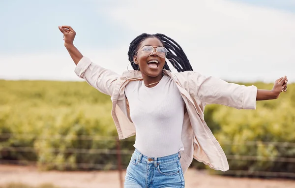 Happy, freedom and excited with black woman in nature and travel for peace, relax and youth. Journey, adventure and happiness with girl enjoying outdoors for summer break, vacation and holiday.