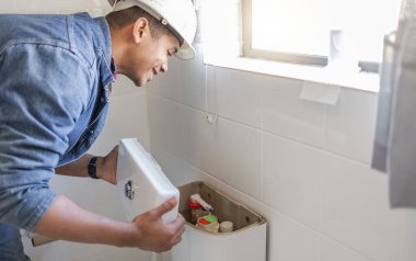 Toilet maintenance, plumber and man fix cistern, home renovation and builder service. Contractor, bathroom tank plumbing and handyman on industrial technician for leak, broken pipe and sewer drainage.