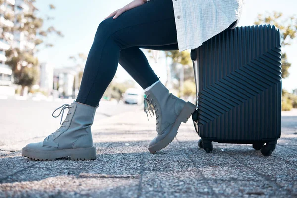 Travel, city and shoes of woman with suitcase ready fpr destination holiday, weekend and vacation. Traveling, journey and feet of girl in urban street with luggage waiting for cab, taxi or transport.