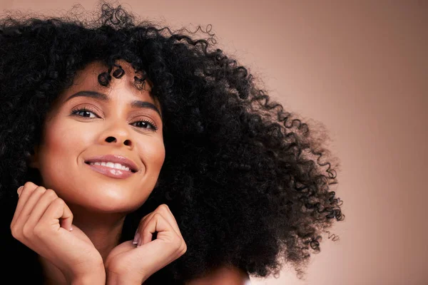 Hair, beauty and portrait of black woman with smile on brown background for wellness, shine and natural glow. Salon, luxury treatment and happy girl face with curly hairstyle, texture and afro growth.