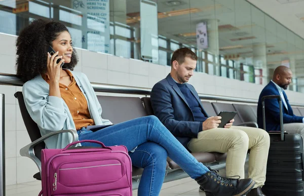 Black woman, phone call and airport in waiting room for conversation, communication or flight delay. African American female talking on smartphone in wait for travel, airplane or departure discussion.