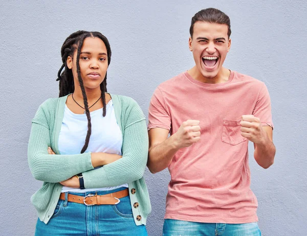 Bored, excited and portrait of an interracial couple with arms crossed, anger and happy about a win. Sad, smile and young man and woman looking angry, comic and mad about losing in a competition.