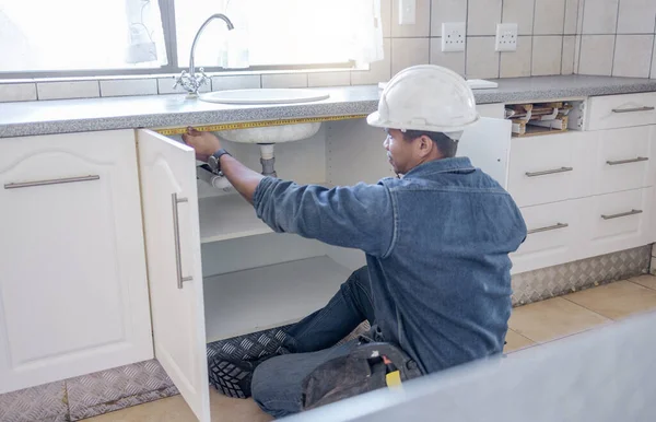 Sink repair, home maintenance and kitchen water pipe check of handyman in a house. Contractor man, builder service and filter improvement installation of a construction employee working in household.