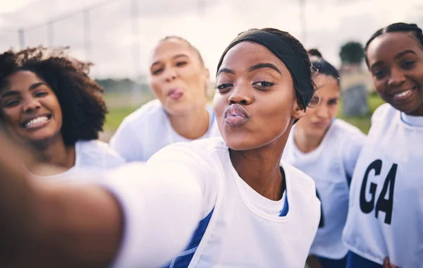 Netball, selfie and portrait of women students on a outdoor sports court for game or workout. Exercise, kiss face and athlete group together for sport, student wellness and teamwork for training.