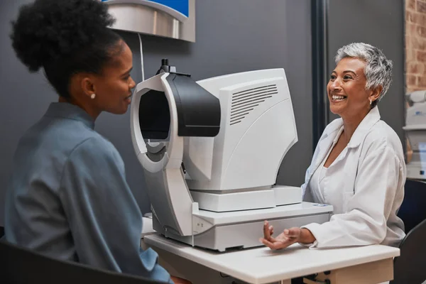 Eye doctor, happy or black woman consulting for eyesight advice at optometrist or ophthalmologist on medical aid. Customer talking or asking questions to check vision health with a senior optician.
