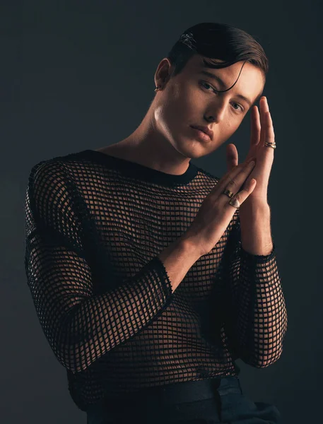 Gender neutral, face and fashion, portrait on dark background and trendy, edgy with hands. Creative, gen z and beauty, sexy and cosmetics with serious non binary person in designer clothes.