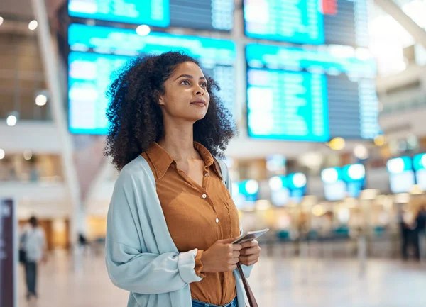 Passport, airport and black woman thinking of international journey, travel information and schedule search in lobby. Young person with identity document at terminal for flight booking or immigration.