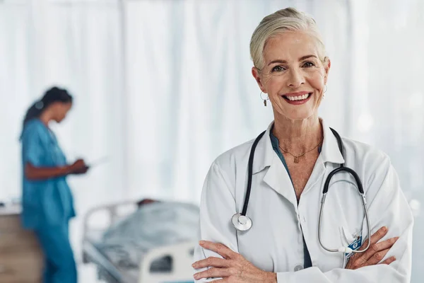 Leadership, smile and portrait of senior woman doctor in hospital with confidence and success in medical work. Health, medicine and face of confident mature professional with stethoscope and mockup