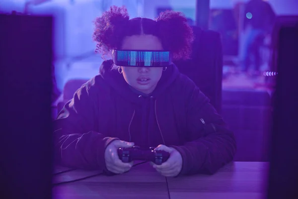 Night, virtual reality and gamer girl with simulation, innovation and vr metaverse in neon lighting. Female gaming, cyberspace tech and glasses for 3D experience, digital AR fantasy and gen z esports.