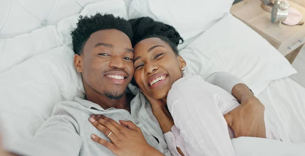 Selfie influencer couple in bed and portrait smile for fun indoor weekend or waking up together in the morning. Fun, happy black people in bedroom and a POV portrait photo for social media content.