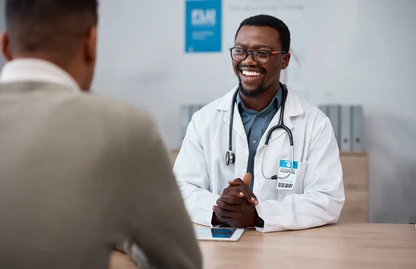 Black man doctor with patient in consultation office for healthcare advice, services and professional support. Medical worker talking, consulting and discussion with client or person in health clinic.