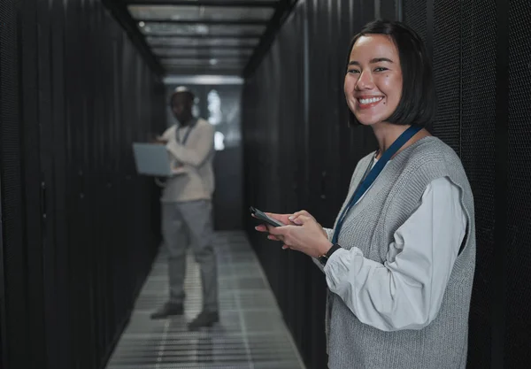 Technician, woman and portrait with phone in server room for digital management, coding and tech. Female engineering, mobile technology and data center for programming, cyber administration and smile.