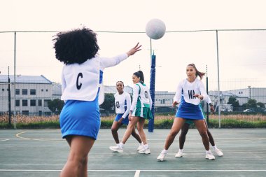 Fitness, sports and netball match by women at outdoor court for training, workout and practice. Exercise, students and girl team with ball for competition, speed and performance while active at field. clipart