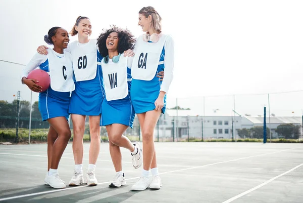 Hug, women or team support in netball training game, exercise or sports workout on college court. Teamwork, fitness friends group or excited athlete girls with happy smile talking or bonding together.
