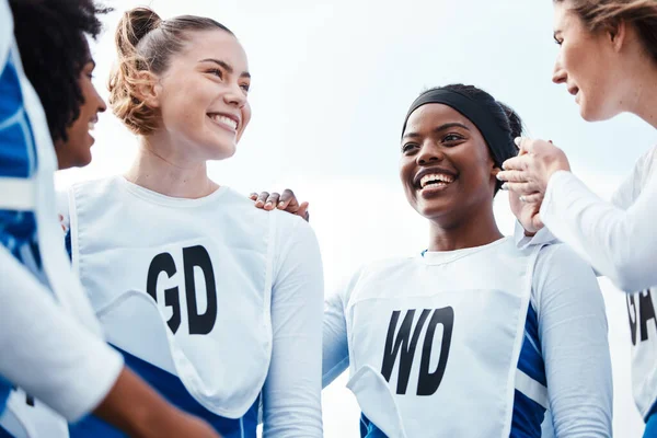 Netball, happy women or sports group with team building, funny conversation and support for training or practice. Athlete friends, people or gen z excited for outdoor game in diversity circle talking.