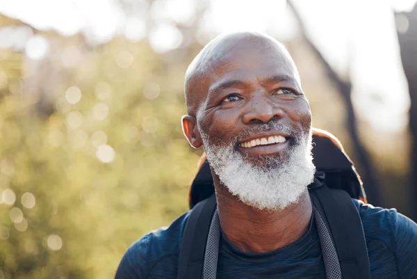 Nature, hiking and senior black man in walking fitness, forest adventure or outdoor travel journey. Elderly hiker person trekking in woods for retirement health, cardio wellness and carbon footprint.
