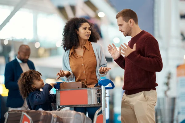 Conflict, travel and interracial family with a problem at airport, flight delay and trouble. Fight, conversation and black woman and man speaking about missing document or late check in with a child.