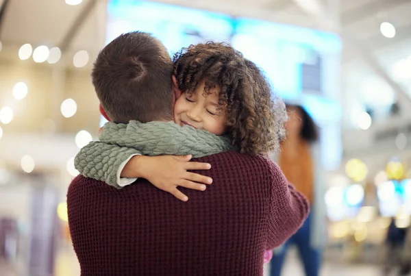 Family, dad and child hug at airport, travel and girl greeting man after flight, happiness and love with luggage at terminal. Happy, care and bond with trip, bag and welcome home with reunion.